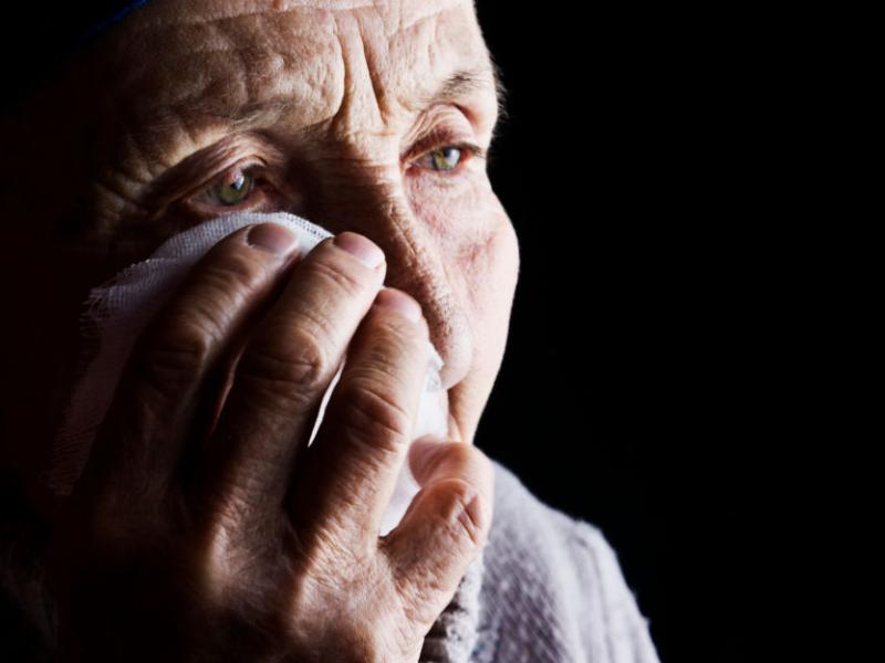 Una mujer mayor se seca las lágrimas